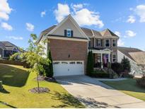 Beautiful brick home featuring a two-car garage and manicured front lawn at 1824 Longmont Dr, Wake Forest, NC 27587