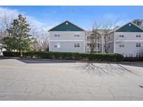Three story apartment building with siding and well-maintained landscaping at 2011 Wolftech Ln # 203, Raleigh, NC 27603
