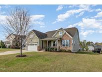 Charming single-Gathering home featuring a well-manicured lawn and inviting front porch at 225 Beckwith Ave, Clayton, NC 27527