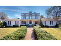 Charming two-story home featuring a manicured lawn, inviting walkway, and classic architectural details at 238 N Main St, Wake Forest, NC 27587