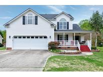 Charming two-story home with a two-car garage, covered porch, and landscaped front yard and a beautiful lawn at 2709 White Rail Dr, Fuquay Varina, NC 27526