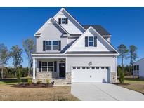 Charming two-story home featuring a gray exterior, white trim, and a well-manicured lawn on a sunny day at 316 Nickleby Way, Wendell, NC 27591