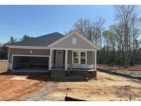 Charming single-story home featuring a two-car garage, covered entrance, and double hung windows at 381 Old Fashioned Way, Lillington, NC 27546