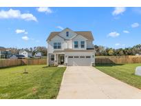 Beautiful two-story home with a well-manicured lawn, two car garage and a long concrete driveway at 4104 Ralph Holt Ct, Snow Camp, NC 27349