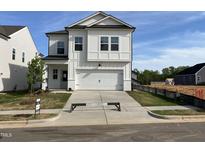 Charming two-story home with white siding, a two-car garage, and a well-manicured front yard at 4310 Emeline Way # 18, Fuquay Varina, NC 27526