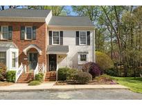 Charming townhouse with brick and siding exterior and manicured front yard at 6750 Olde Province Ct, Raleigh, NC 27609