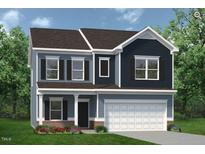 Charming two-story home featuring a two-car garage, black shutters, and manicured landscaping at 144 E Victory View Ter # 66, Smithfield, NC 27577