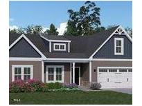 Charming single-story home with a two-car garage, dormer, and well-maintained landscaping at 146 Surles Landing Way, Benson, NC 27504