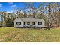 Charming single-story home with a welcoming front porch, black shutters, and a well-manicured lawn at 188 Hunter Ln, Zebulon, NC 27597