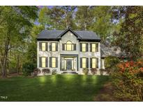 Beautiful two-story home with a well-manicured lawn and mature trees, providing great curb appeal at 201 Wortham Dr, Raleigh, NC 27614