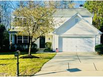 Charming two-story home boasts a well-manicured lawn, attached garage, and lovely curb appeal at 3316 Perkins Ridge Rd, Raleigh, NC 27610