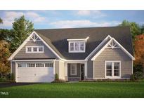 Charming single-Gathering home with gray siding, a well-manicured lawn, and a two-car garage at 38 N Blue Sly Trl # 56, Selma, NC 27576