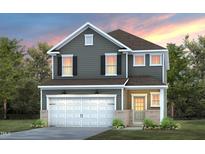 Charming two-story home with gray siding, white trim, and a welcoming two-car garage at 509 Providence Springs Ln, Fuquay Varina, NC 27526