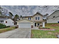 Charming two-story home with attached garage and beautiful landscaping at 613 Ashburn Ln, Durham, NC 27703