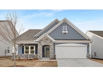 Charming single Gathering home with stone accents, blue siding, and a welcoming two car garage at 63 Mable Court # 6, Lillington, NC 27546