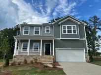 Charming two-story home with a covered porch and a two-car garage at 70 Cordoba Dr, Franklinton, NC 27525