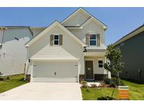 Two story home featuring a two car garage, craftsman style accents, manicured lawn, and new construction at 84 Commons Cir, Clayton, NC 27520