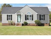 Charming single-story home with light siding, black shutters, and a well-manicured front lawn at 105 Seminole Dr, Wendell, NC 27591