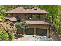 Stunning exterior view of a modern home featuring a two-car garage and pristine landscaping at 111 Standing Rock Rd, Chapel Hill, NC 27516