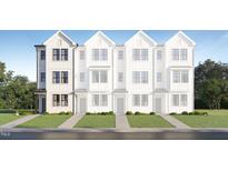 Charming exterior of a newly constructed townhome features white siding and black framed windows at 1546 Crescent Townes Way, Raleigh, NC 27604