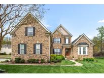 Beautiful brick home with manicured lawn and mature landscaping at 1808 Pattersons Mill Rd, Durham, NC 27703