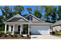 Charming one-story home with a covered front porch, attached garage, and beautiful architectural details at 1917 Malvina Ct, Graham, NC 27253