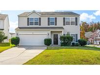 Traditional two-story home featuring a two-car garage, manicured lawn, and neutral siding at 2 Bolter Ct, Durham, NC 27704