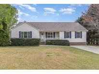 Charming single-story home featuring blue shutters, a manicured lawn, and a welcoming front porch at 201 Alice Dr, Garner, NC 27529