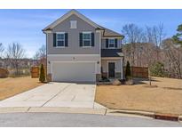 Charming two-story home with a gray exterior, neat landscaping, and a two-car garage at 2040 Water Marsh Trl, Fuquay Varina, NC 27526