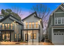 Charming two-story new home with a balcony and modern design elements, framed by neighboring houses at 2212 Edwin Ave # A, Durham, NC 27705