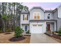 Charming two-story home with gray siding, manicured landscaping, and attached one-car garage at 4220 Congleton Pl, Durham, NC 27703