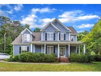 Charming two-story home featuring a welcoming front porch and beautifully manicured landscaping at 4516 Ocean Crest Cir, Raleigh, NC 27603