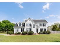 Charming two-story home with a well-manicured lawn and inviting curb appeal at 5745 Spence Farm Rd, Holly Springs, NC 27540