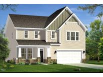 Charming two-story home with a two-car garage, a front porch, and a well-manicured lawn and landscaping at 779 Old Station Pointe, Angier, NC 27501