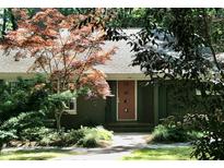 Charming single story home with a red front door and lush landscaping at 817 Old Mill Rd, Chapel Hill, NC 27514