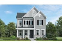 Charming two-story home with gray siding, black shutters, and stone accents on the front exterior at 304 Calvander Ln, Apex, NC 27539