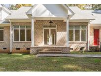 Charming brick home featuring a covered front entrance with classic columns and ample natural light at 1021 Reaves Dr Dr, Chapel Hill, NC 27516