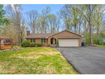 Charming brick home with attached garage and well-maintained lawn and paved driveway at 1525 Rogers Rd, Graham, NC 27253