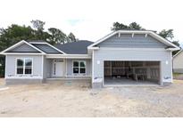 New construction home featuring light gray siding, black roof, and an attached two car garage at 1547 Pecan Drive # 31, Nashville, NC 27856