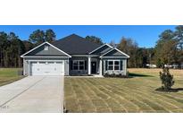 Charming single-story home boasts stone accents, a two-car garage, and a well-manicured front lawn at 1565 Pecan Drive # 30, Nashville, NC 27856