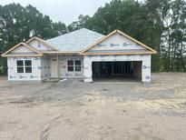 A home under construction with Barricade wrap, a two-car garage, and a gravel yard at 1565 Pecan Drive # 30, Nashville, NC 27856
