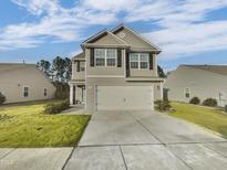 Charming two-story home with a well-maintained lawn and two car garage at 2053 Alderman Way, Creedmoor, NC 27522