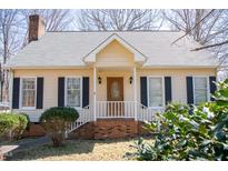 Charming single-story home featuring a front porch and meticulously maintained landscaping at 401 Joyce Rd, Hillsborough, NC 27278