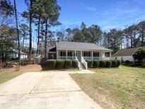 Charming single-story home featuring a welcoming front porch and well-maintained landscaping at 5605 Christie Ln, Durham, NC 27713