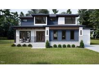 Beautiful home with blue and white color scheme, lush lawn, attractive stone accents and modern design at 95 Cherry Bark Dr, Youngsville, NC 27596