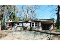 Charming one-story home featuring a brick exterior, covered carport, and manicured landscaping at 1212 St. Marys Rd, Hillsborough, NC 27278