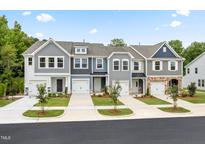 Charming townhomes featuring unique exterior elevations with landscaped front yards on a tree-lined street at 1255 Hammond Dr, Mebane, NC 27302