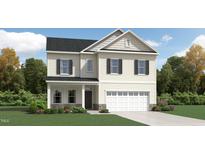 Charming two-story home with a symmetrical facade, attached garage, and well-maintained landscaping at 1505 Bright Coral Trl, Wendell, NC 27591