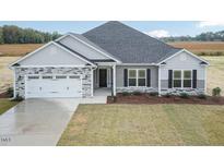 Charming single-story home featuring stone accents, a two-car garage, and a well-manicured lawn at 1579 Pecan Drive # 29, Nashville, NC 27856
