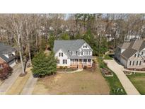 Charming two-story home with a welcoming front porch and beautiful landscaped yard at 2021 Terri Creek Dr, Fuquay Varina, NC 27526